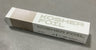 White and beige Kosher Foil aluminum foil box marked EZ Roll and 100, lying on a gray floor