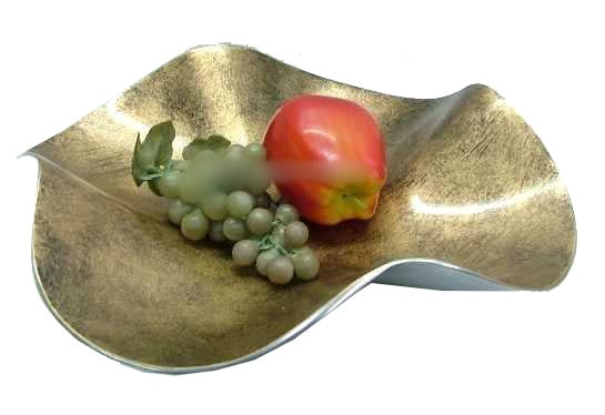 Wavy aluminum fruit dish with brushed gold-tone interior holding an apple and grapes