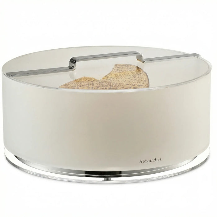 Round ivory acrylic matzah box with clear lid, silver bar handle and silver ring at the base