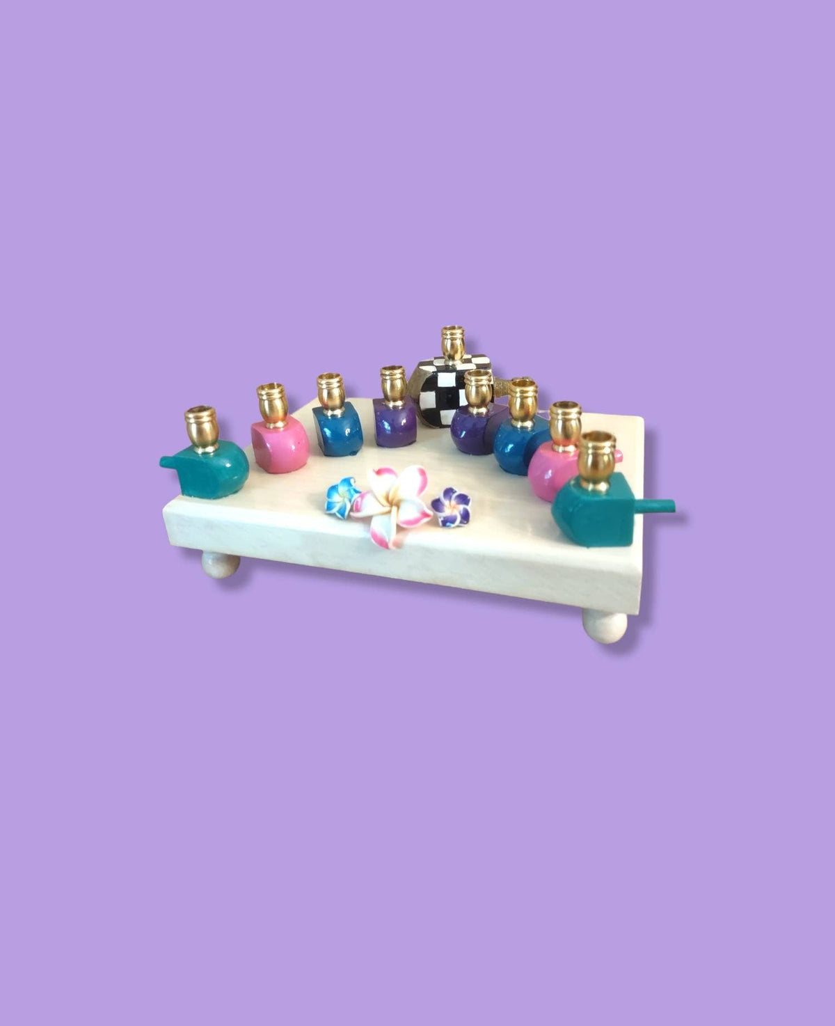 Jewel tone dreidel menorah, angled view on purple