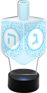 Clear acrylic Chanukah dreidel glowing while spinning