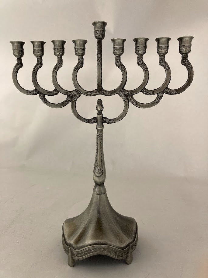 Gray pewter candle menorah with curved arms, a raised center shamash and a flared base