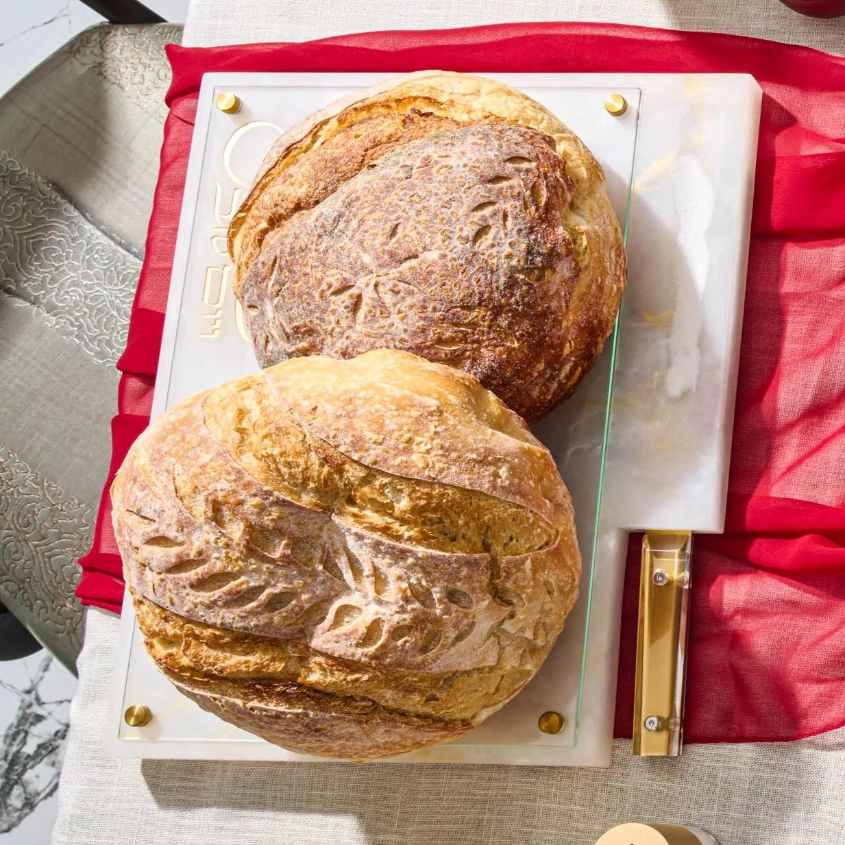 Marbled resin challah board showing built-in salt indent and knife slot