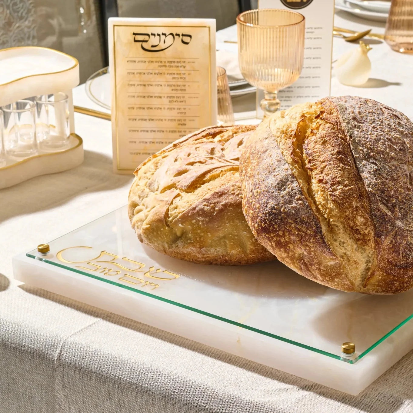 Waterdale resin challah board displayed with challah on a Shabbos table