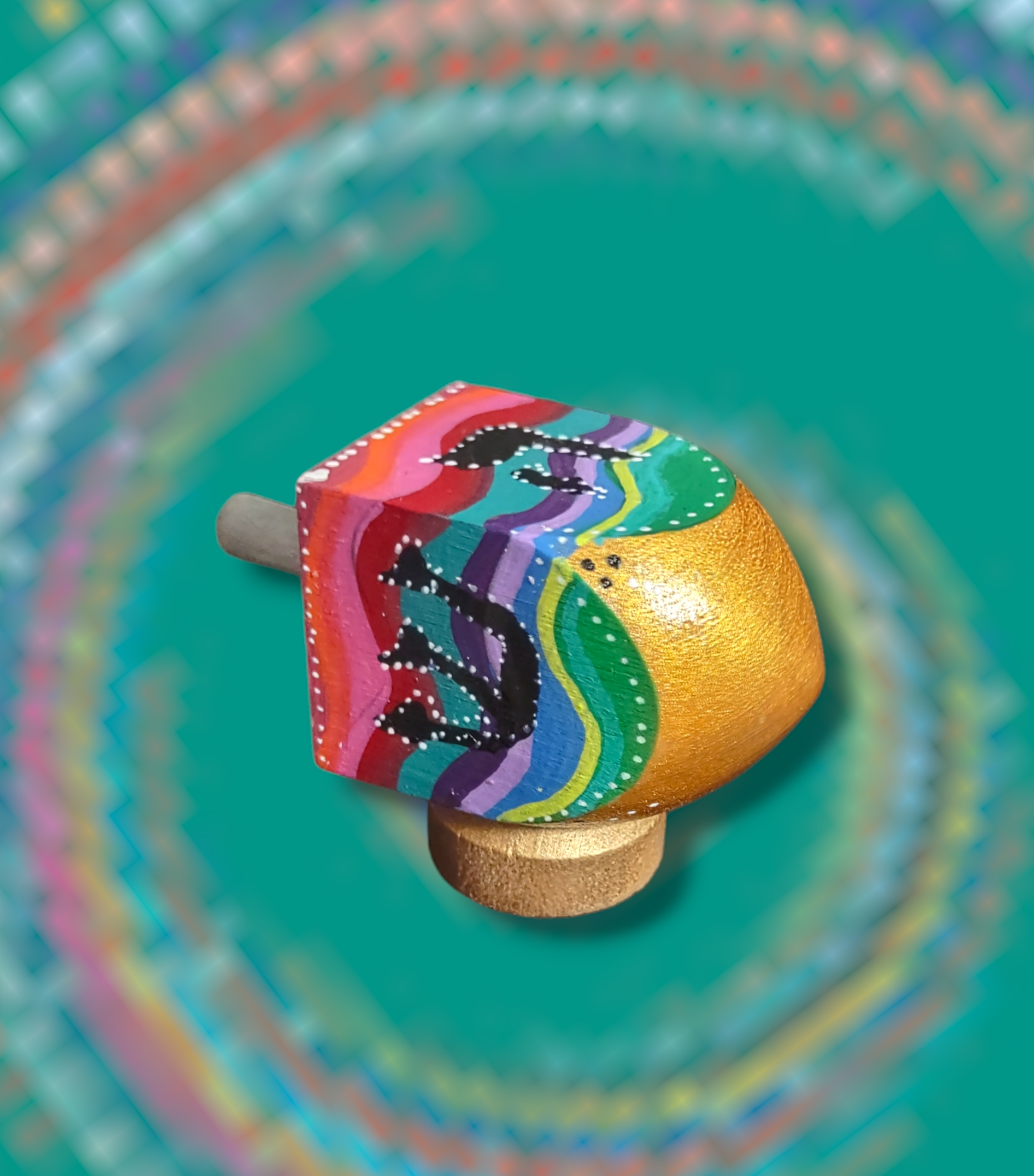 Swirl dreidel — colorful hand-painted wooden dreidel with swirling stripes on a stand | Judaica Square Lakewood (view 3)
