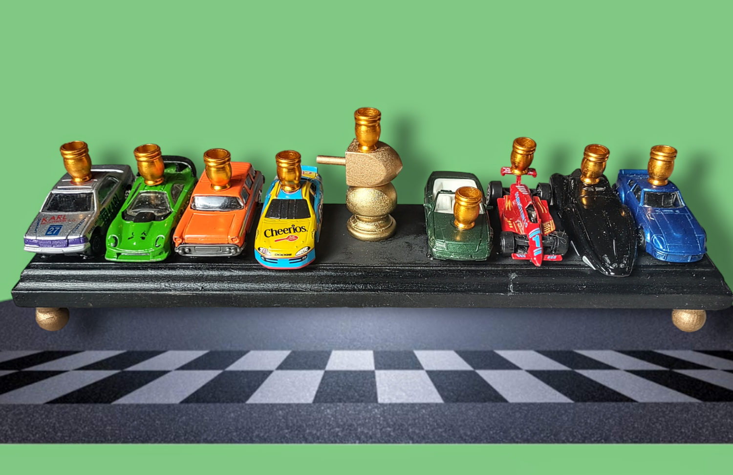 Matchbox car menorah — row of repurposed toy cars with aluminum candle cups | Judaica Square Lakewood (view 3)