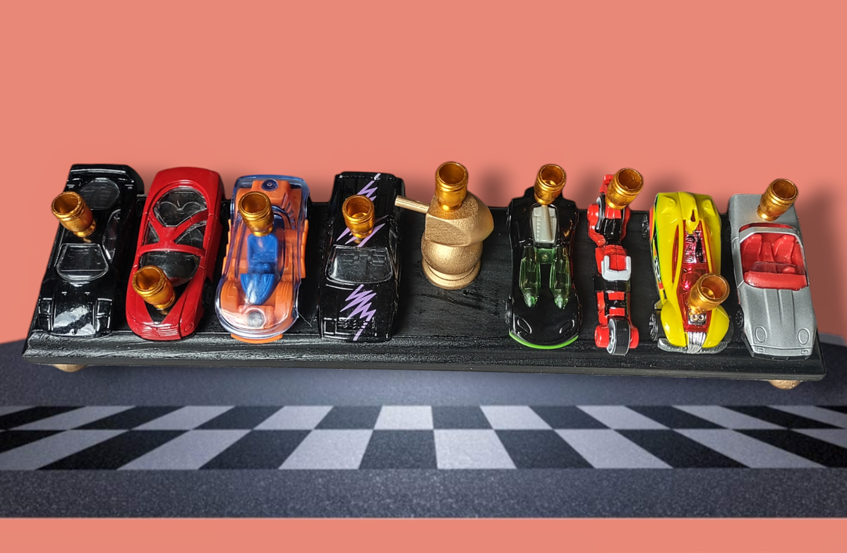 Matchbox car menorah — row of repurposed toy cars with aluminum candle cups | Judaica Square Lakewood (view 2)