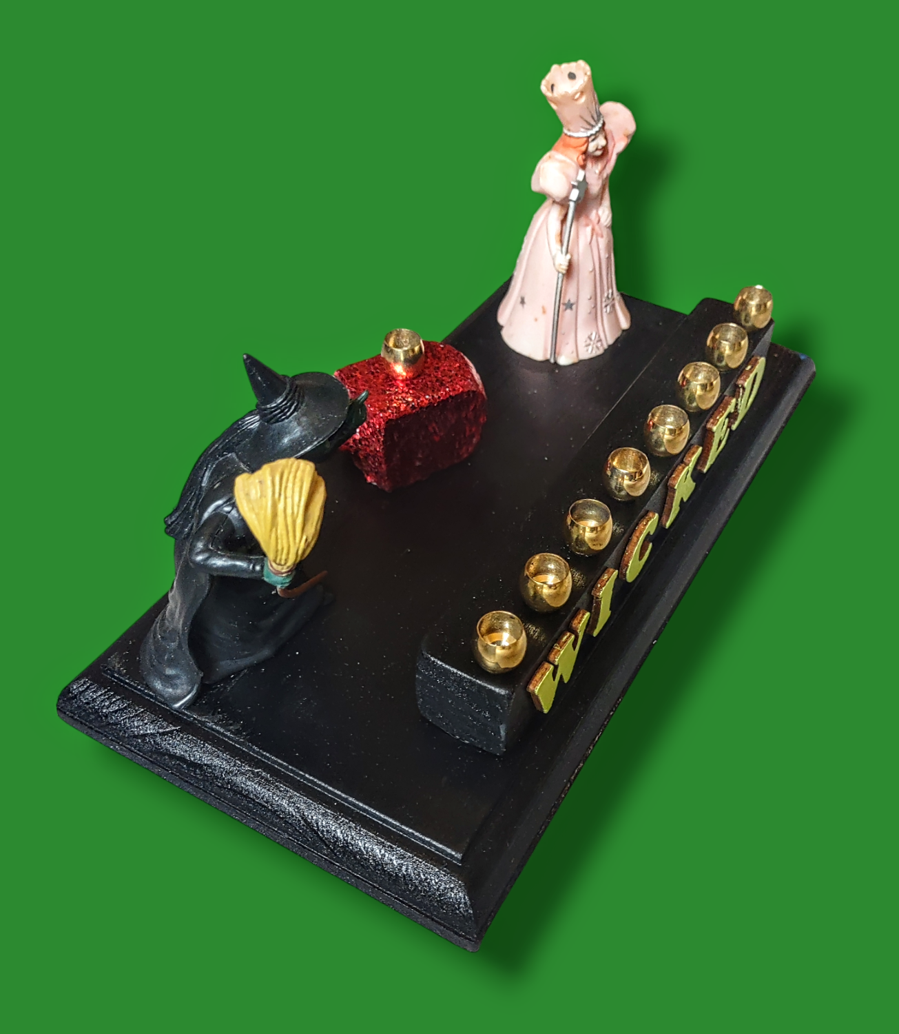 Wicked menorah — Elphaba and Glinda figures with ruby red dreidel and brass candle cups | Judaica Square Lakewood (view 5)