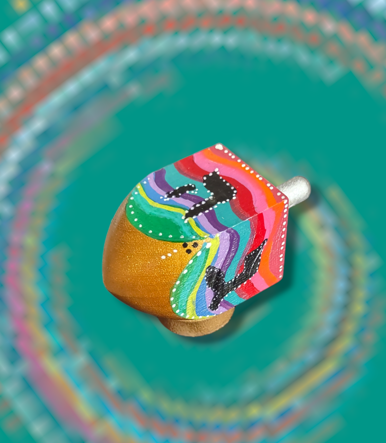 Swirl dreidel — colorful hand-painted wooden dreidel with swirling stripes on a stand | Judaica Square Lakewood (view 2)