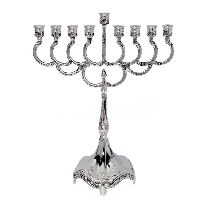 Small silver-plated menorah with curved arms, a raised shamash and a flared scalloped base