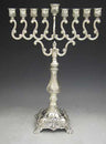 Silver plated menorah with S-scroll arms, ornate cups and a footed base with shell decoration