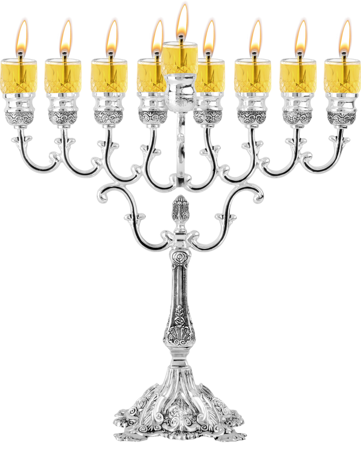 Silver-plated oil menorah with lit glass cups in a level row and an ornate stem and base