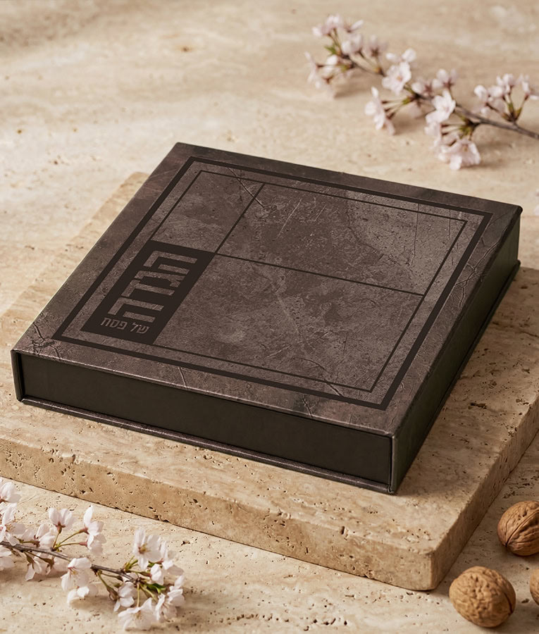 Simchonim faux leather 8x8 Haggadah, shown on a table setting