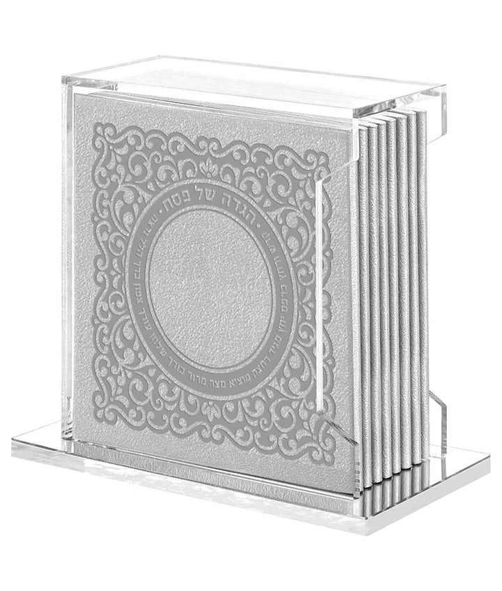 Simchonim Lucite stand holding Lacey style Haggados in silver
