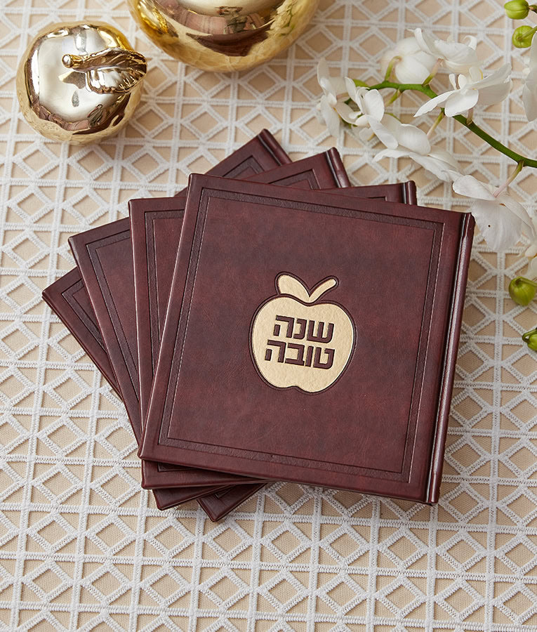 Simchonim apple style Shanah Tovah booklet, shown on a table setting