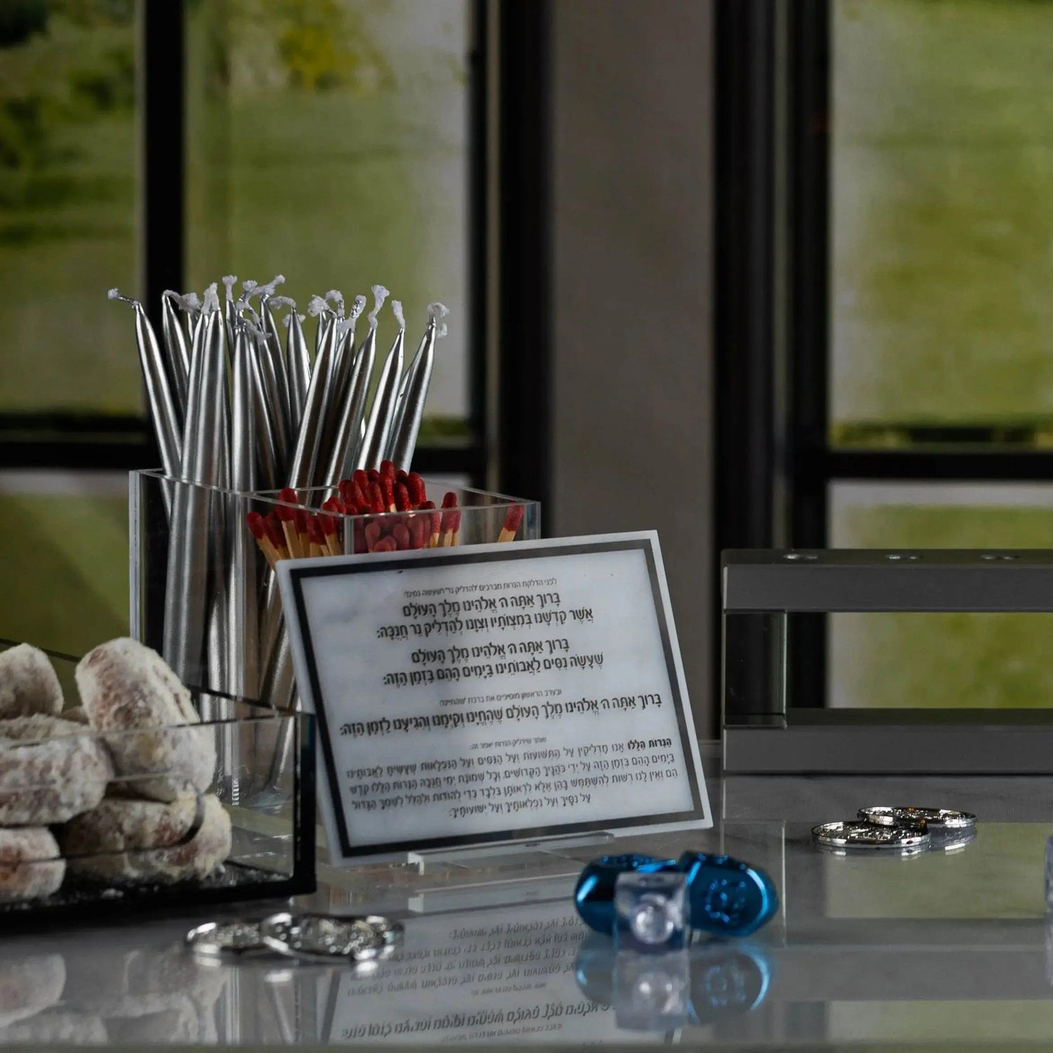 Chanukah candle holder shown with a lucite brachos card on the base