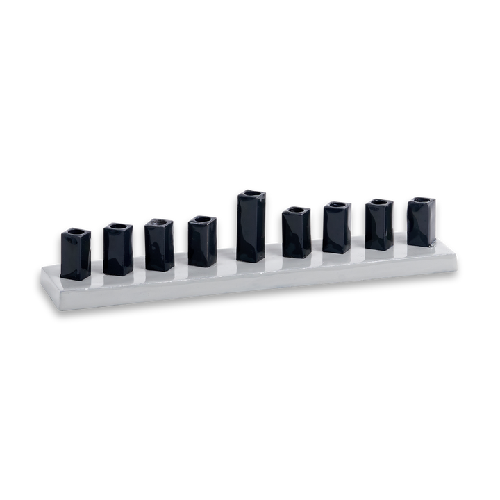 Strip menorah with a pale gray enamel base and nine glossy dark navy square cups, center shamash raised