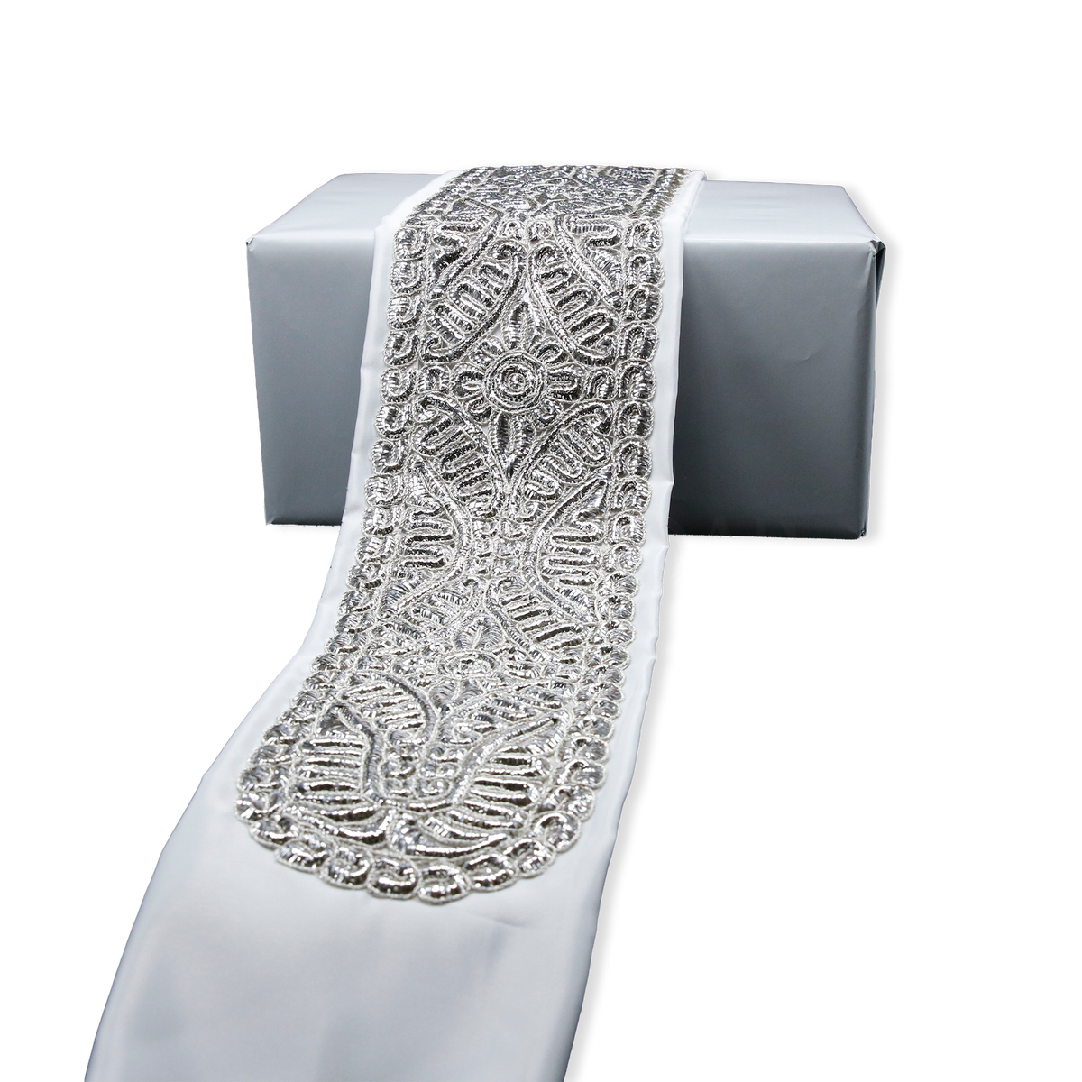 Traditional silver atarah with ornate woven design on satin