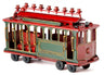 Red and green metal trolley car menorah with cups on the roof