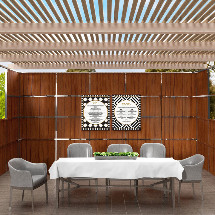 Kiddush and Ushpizin Lucite signs hanging on a wooden sukkah wall outdoors