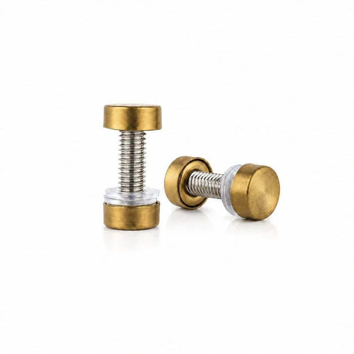 Pair of gold-finish challah board screws, one standing and one on its side, on white