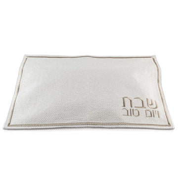 Cream fabric challah cover with gold-embroidered 'Shabbos Yom Tov' lettering and classic line border