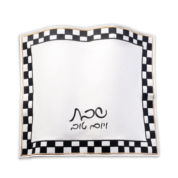 Onyx Challah Cover laid flat, showing the black-and-white checkered border, gold edging and embroidered Hebrew text