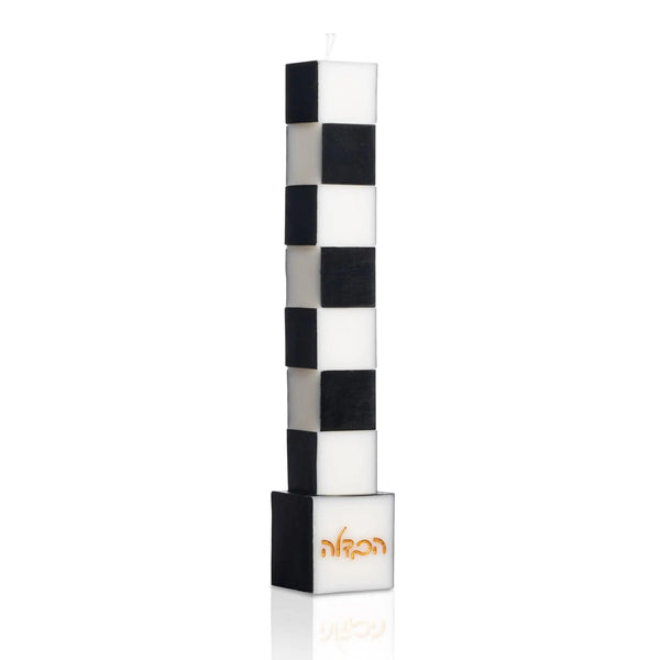 Onyx Havdalah Candle, a tall freestanding black and white checkered candle on a black base with embossed gold הבדלה lettering