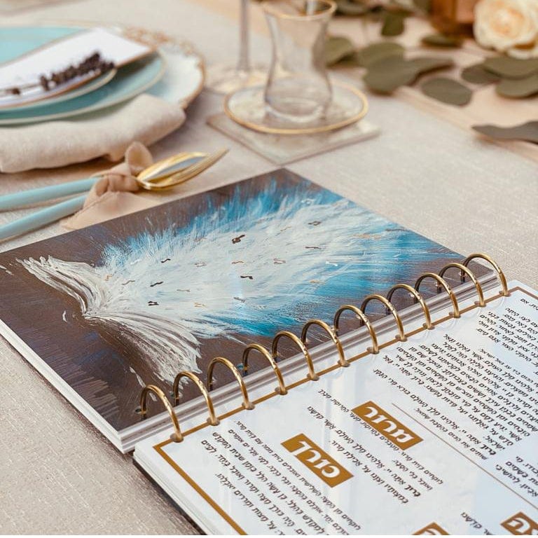 Painted Krias Yam Suf Haggadah — in use | Judaica Square Lakewood