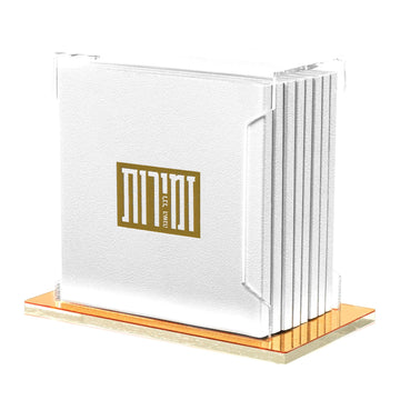 Gold softcover Zemiros bencher set in a clear Lucite holder with rose-gold base