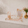 The set staged on its tray with the brachos block, tzedakah box and matchbox holder; the candlesticks pictured are not included