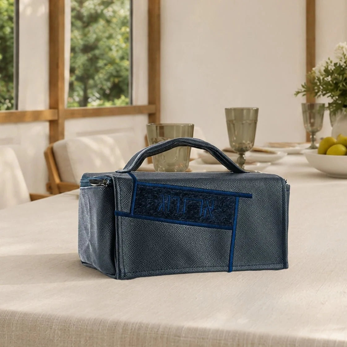 Navy Waterdale geometric esrog bag displayed in a dining-room setting