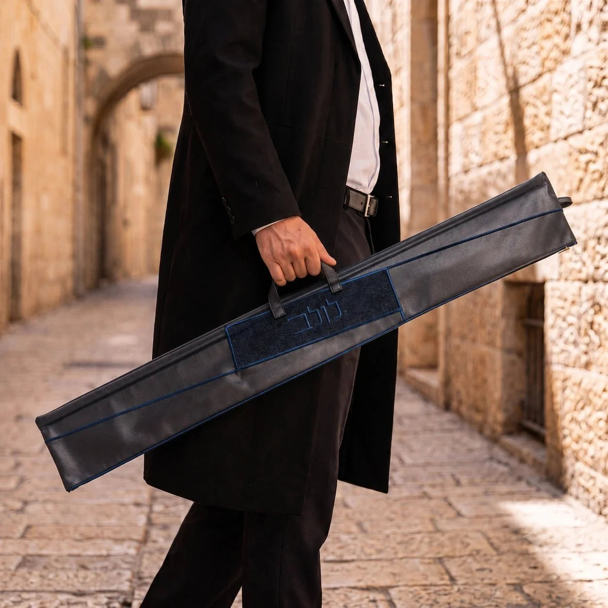 Navy Waterdale geometric lulav case shown carried by its handle
