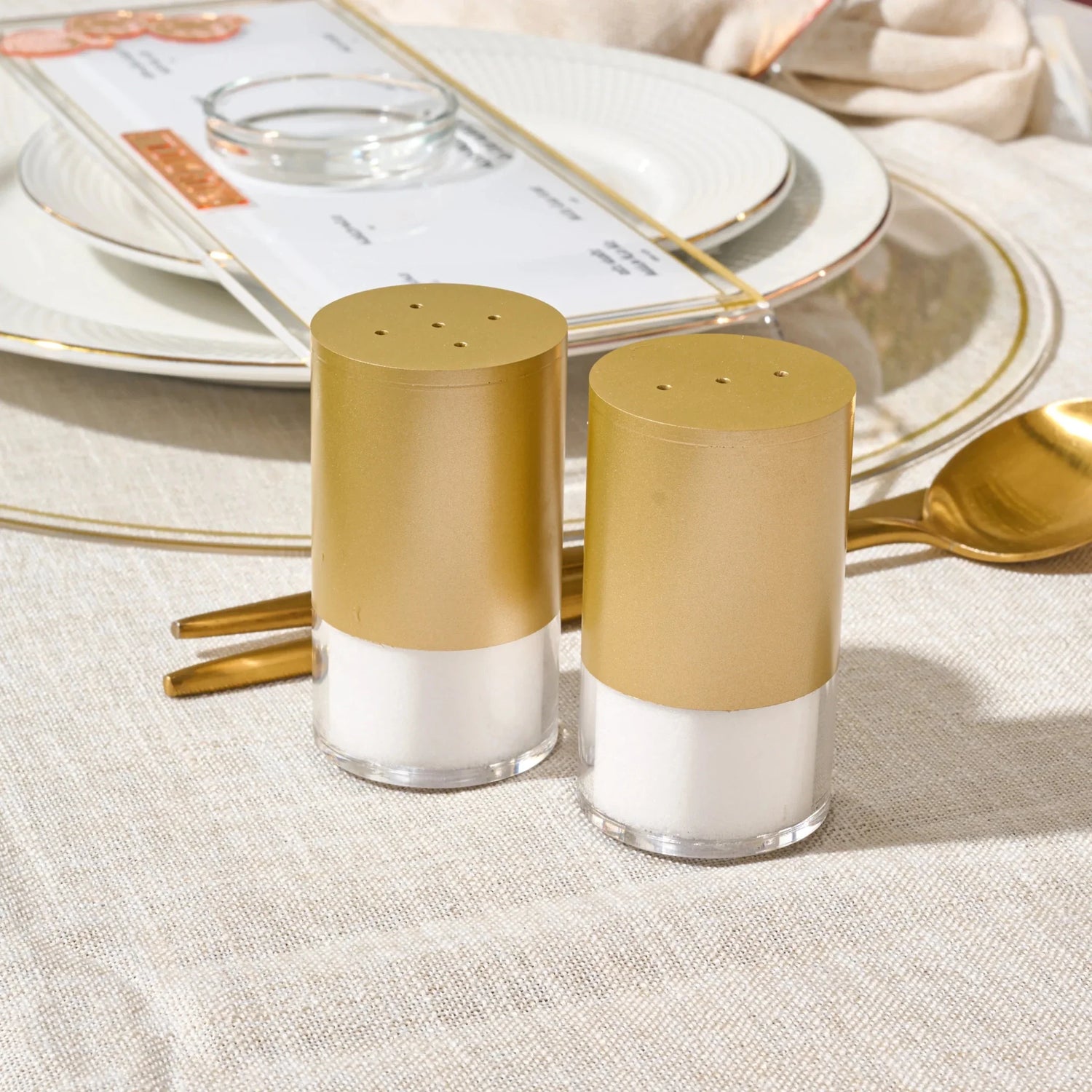 Gold Waterdale salt and pepper shaker pair displayed on a dining table