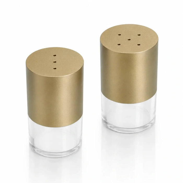 Gold Waterdale salt and pepper shaker pair with clear acrylic bases, studio view
