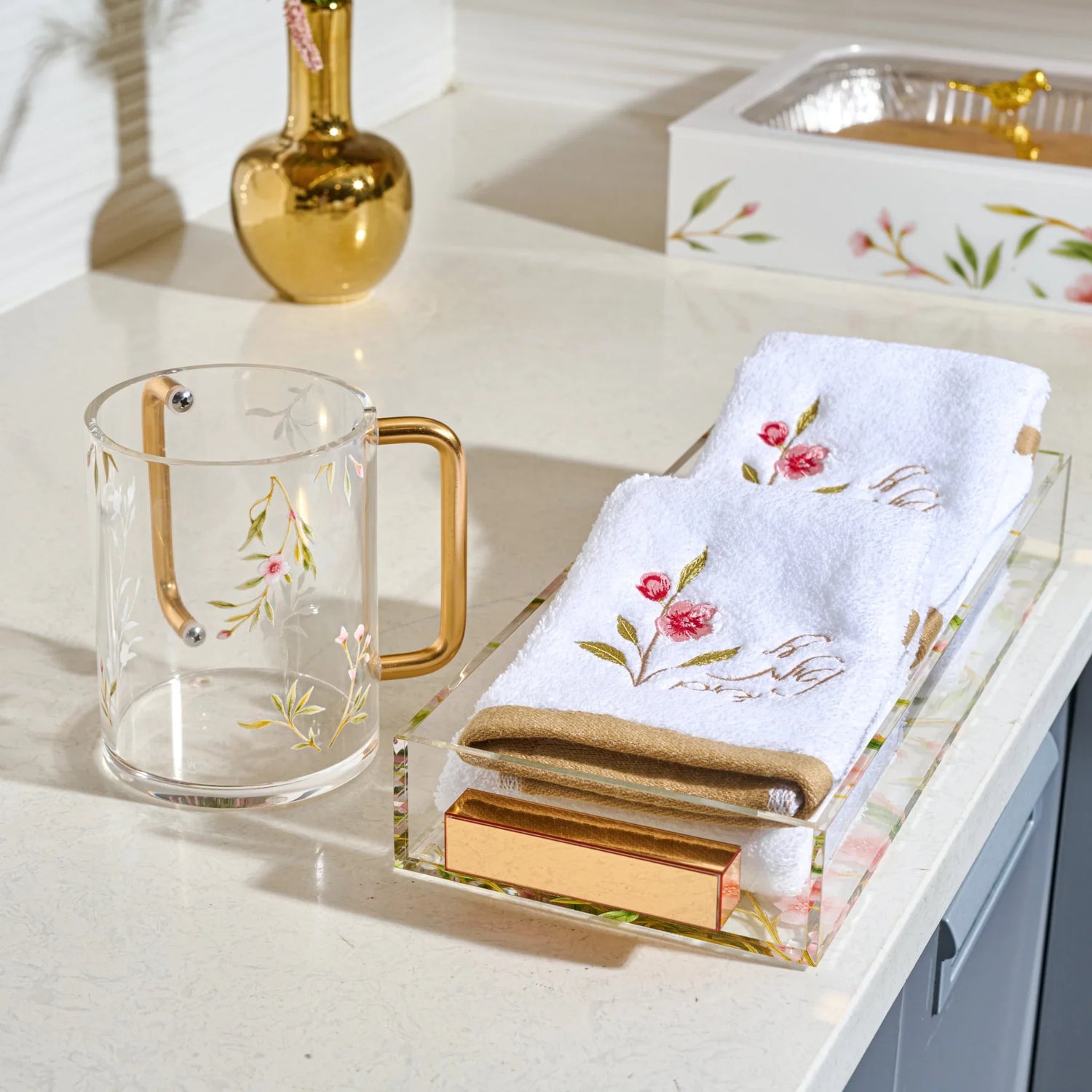 Pink floral Netilas Yadayim towels displayed with a floral washing cup on a Lucite tray