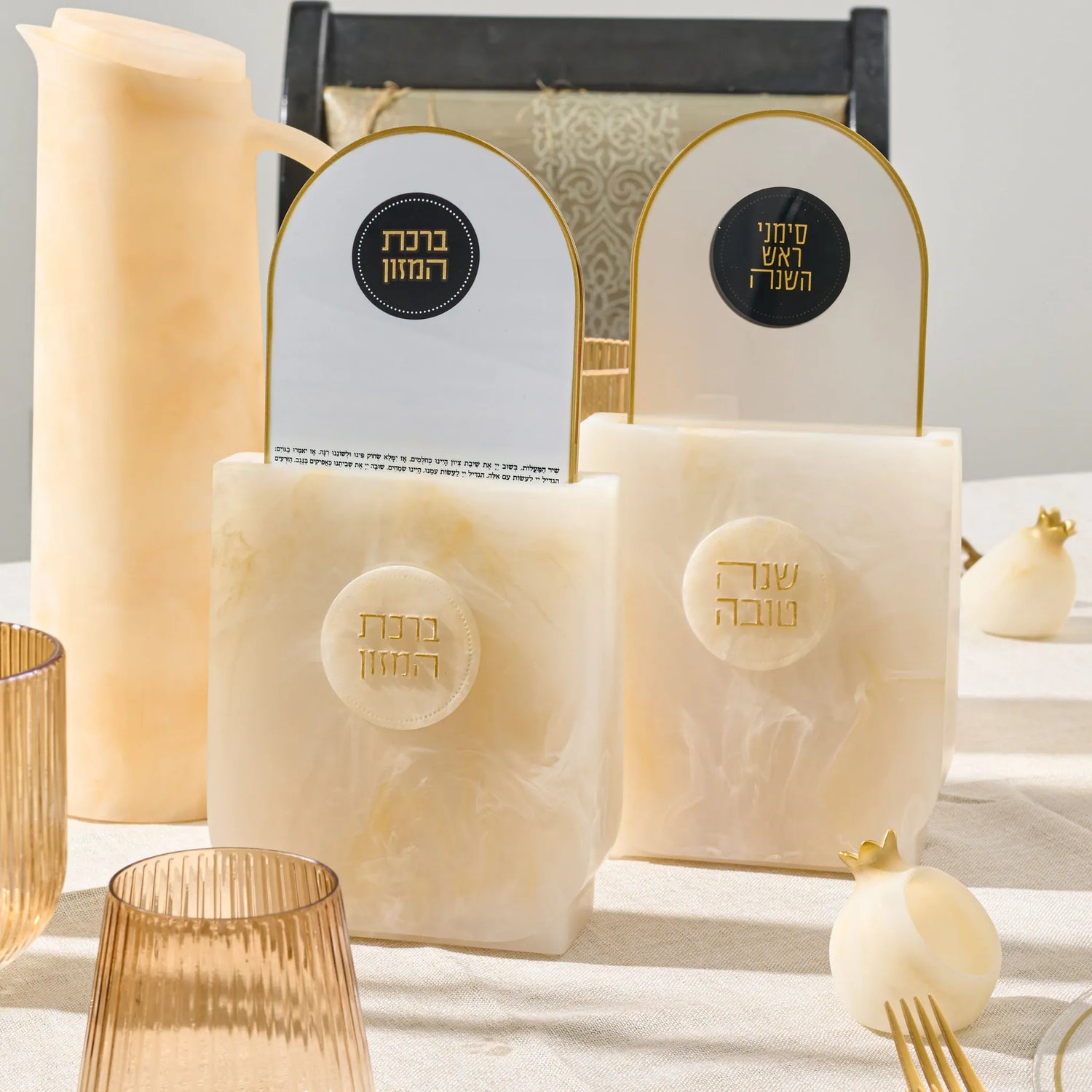 Waterdale resin arch bencher set beside a separate Shana Tova and Simanim holder in a styled table scene