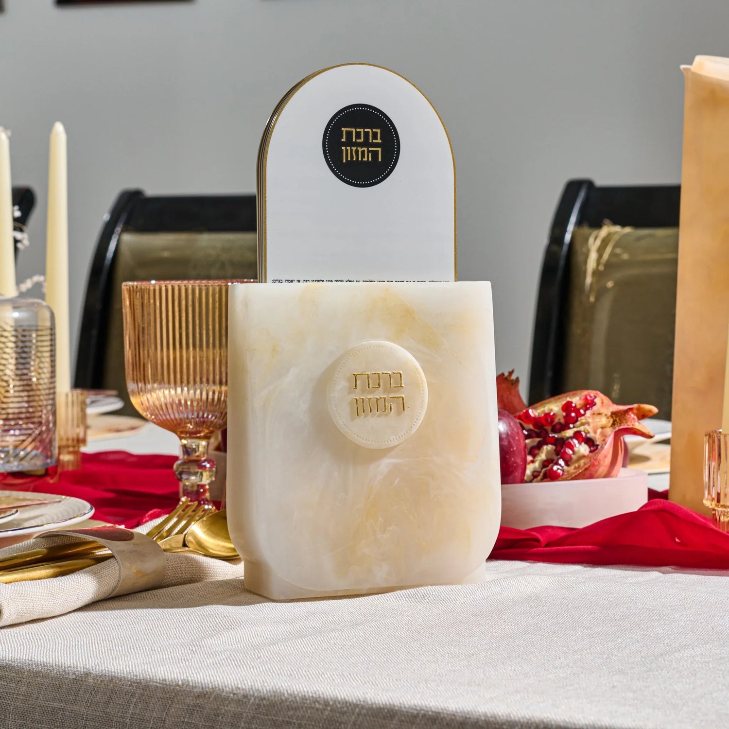 Gold-accented Waterdale resin arch bencher holder with a Lucite Birchas Hamazon card on a styled table