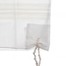 Corner detail of white-on-white wool tallis katan with tzitzis strings
