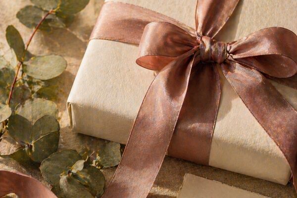 Curated Judaica gifts wrapped with greenery